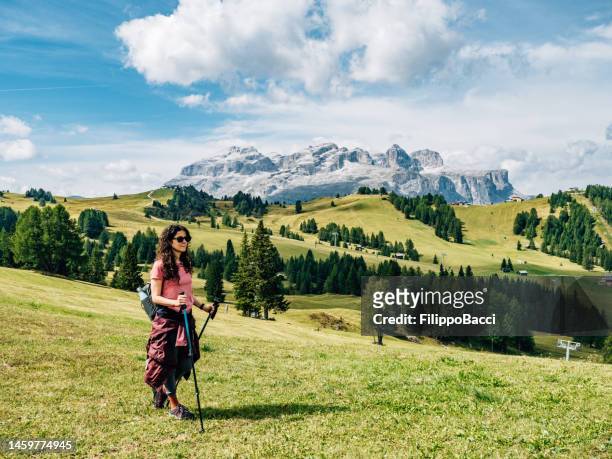 a woman is hiking outdoor on italian alps - alta badia bildbanksfoton och bilder