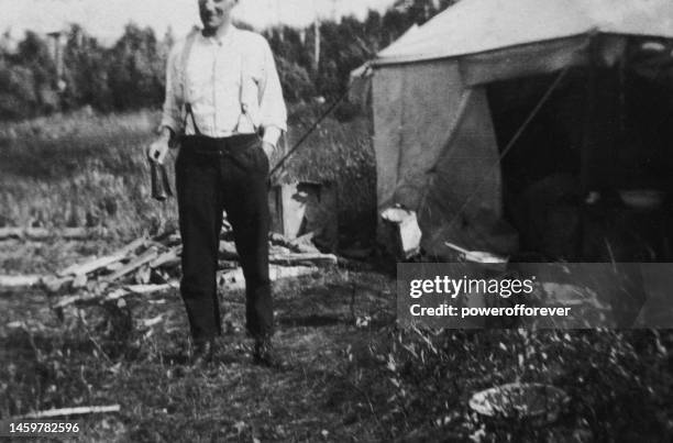 camp cook ringing bell for dinner at a survey expedition camp in saskatchewan, canada - 1919 - black and white landscape stock pictures, royalty-free photos & images