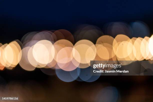 defocused image of illuminated lights - eeuwigheid stockfoto's en -beelden