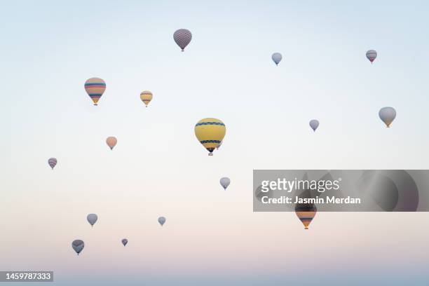 hot air balloons at sunrise. cappadocia, turkey - hot air balloon ride stock-fotos und bilder