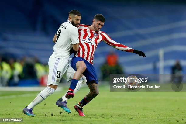 Karim Benzema of Real Madrid competes for the ball with Rodrigo de Paul of Atletico de Madrid during the Copa Del Rey Quarter Final match between...