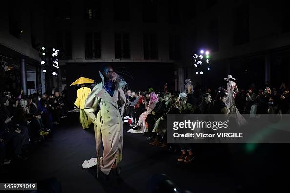A model walks the runway during the Robert Wun Haute Couture... News ...