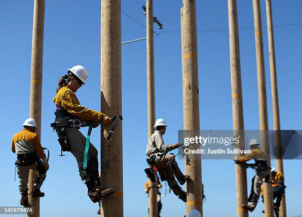 Students participating in Pacific Gas and Electric's PowerPathway Pole Climbing Capstone course climb utility poles at the PG&E pole climbing...