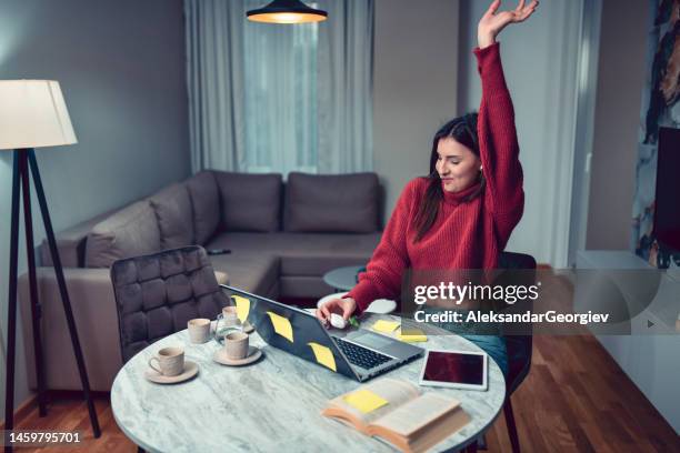 female stretching out and ready to put some music on while finishing bookkeeping tasks - of deformed people stock pictures, royalty-free photos & images