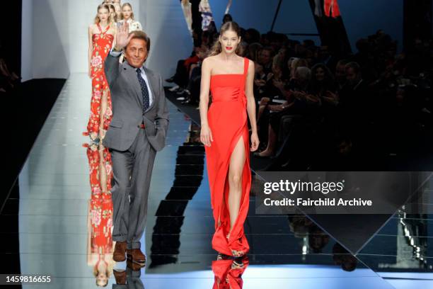 Fashion designer Valentino Garavani and model Doutzen Kroes on the runway after Valentino's spring 2006 show at Le Carrousel du Louvre.