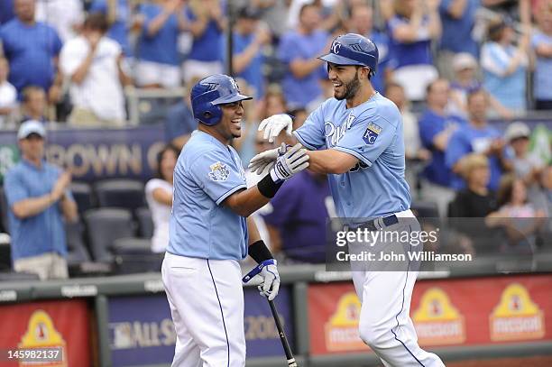 Eric Hosmer of the Kansas City Royals celebrates his home run with Brayan Pena as he returns to the dugout after rounding the bases in the game...