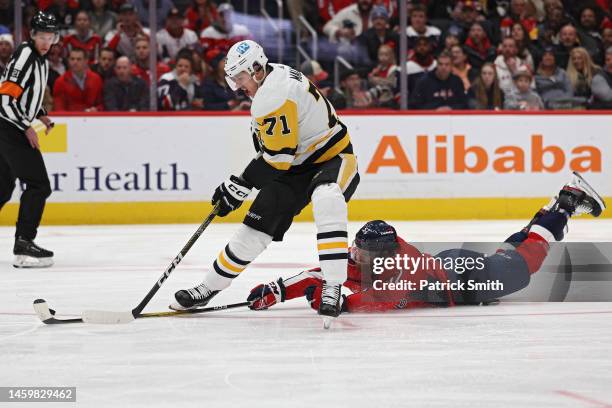 Evgeni Malkin of the Pittsburgh Penguins has the puck stolen by Matt Irwin of the Washington Capitals during the first period at Capital One Arena on...