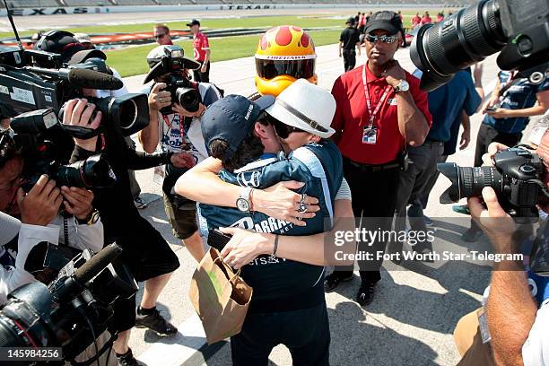 Indy Car driver Alex Tagliani is congratulated by his wife, Bronte, after he won the pole position during qualifying for the Firestone 550 at Texas...