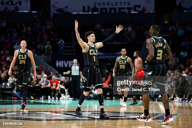 LaMelo Ball and Terry Rozier of the Charlotte Hornets react following a basket during the second half of the game against the Chicago Bulls at...