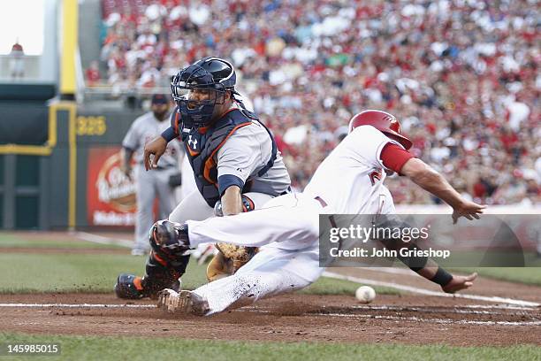 Gerald Laird of the Detroit Tigers loses the ball at homeplate allowing Zack Cozart of the Cincinnati Reds to score during their game at Great...