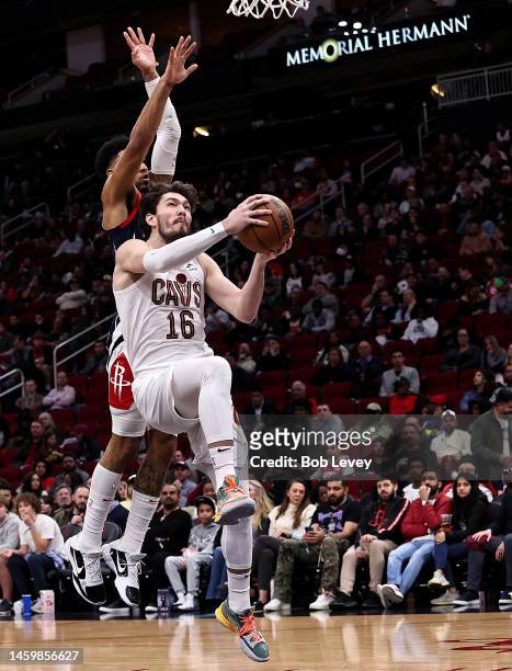 Cedi Osman of the Cleveland Cavaliers drives past Kenyon Martin Jr. #6 of the Houston Rockets for a layup during the fourth quarter of the game at...