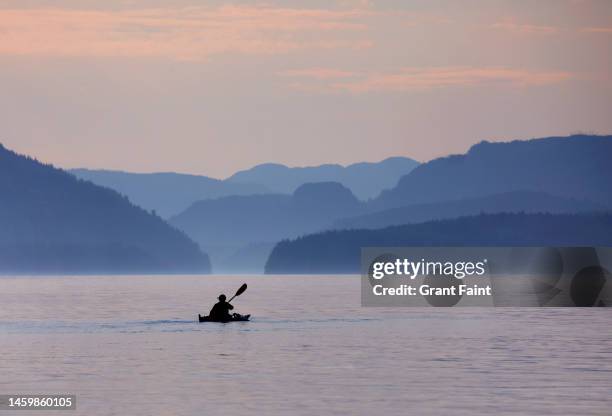 a single kayaker at dawn. - nanaimo stock pictures, royalty-free photos & images