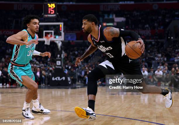 Paul George of the LA Clippers drives to the basket on Tre Jones of the San Antonio Spurs during the first half at Crypto.com Arena on January 26,...