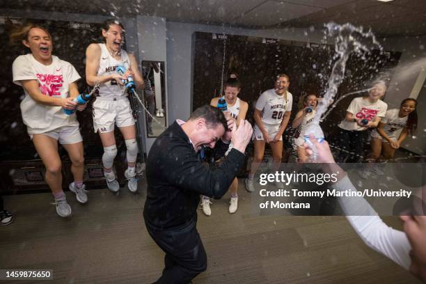 Head coach Brian Holsinger of the Montana Grizzlies gets showered in the locker room after a game against the Sacramento State Hornets at Dahlberg...