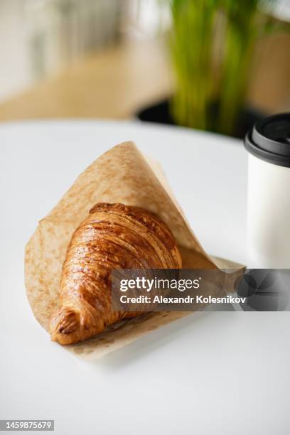 tasty fresh croissant in paper bag. concept of delivery food, small business. copy space - breaking croissant stock pictures, royalty-free photos & images