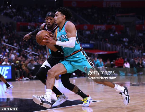 Tre Jones of the San Antonio Spurs drives to the basket in front of Amir Coffey of the LA Clippers during a 138-100 Clippers win at Crypto.com Arena...