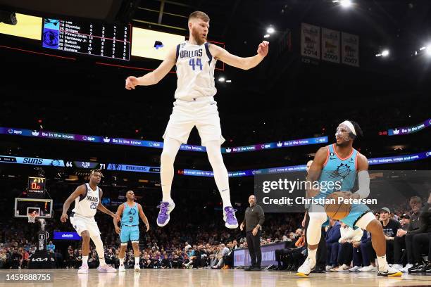 Josh Okogie of the Phoenix Suns handles the ball as Davis Bertans of the Dallas Mavericks defends during the second half of the NBA game at Footprint...