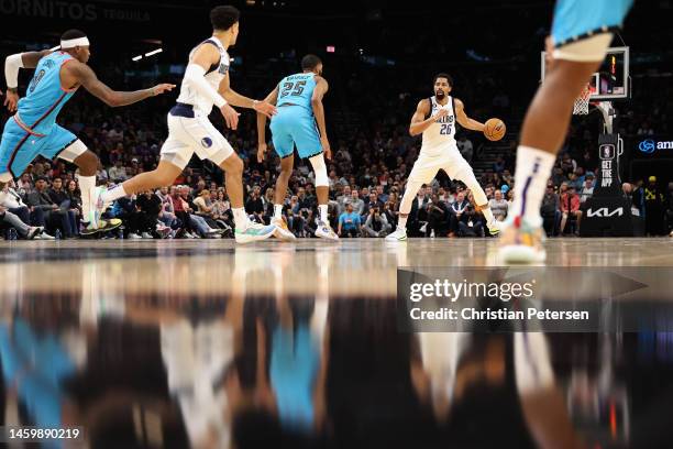 Spencer Dinwiddie of the Dallas Mavericks handles the ball against Mikal Bridges of the Phoenix Suns during the first half of the NBA game at...