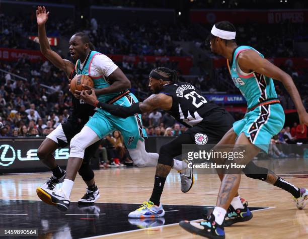 Gorgui Dieng of the San Antonio Spurs drives to the basket in front of Robert Covington of the LA Clippers during a 138-100 Clippers win at...