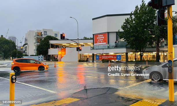 Cars drive through floodwaters on Victoria Street on January 27, 2023 in Auckland, New Zealand. Heavy rainfall, the most rain ever recorded in one...