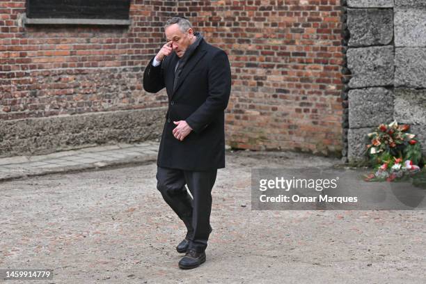 Second Gentleman, Douglas Emhoff, reacts after laying wreaths honoring victims of the Nazi regime by the death wall during the Holocaust Remembrance...