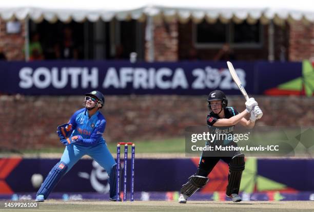 Kate Irwin of New Zealand hits out as Wicket Keeper Richa Ghosh of India looks on during the ICC Women's U19 T20 World Cup 2023 Semi Final match...