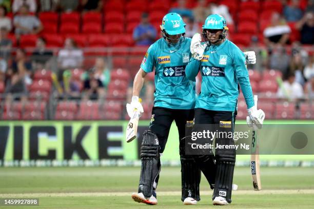 Marnus Labuschagne of the Heat congratulates captain of the Heat Usman Khawaja on his innings during the Men's Big Bash League match between the...