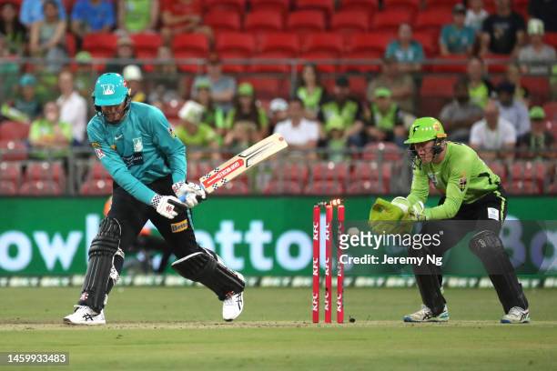 Matt Renshaw of the Heat is dismissed by Chris Green of the Thunder during the Men's Big Bash League match between the Sydney Thunder and the...