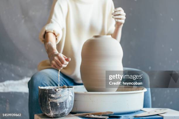 hands working on pottery wheel - arts and crafts stock pictures, royalty-free photos & images