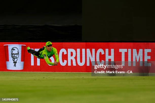 Chris Green of the Thunder saves a four during the Men's Big Bash League match between the Sydney Thunder and the Brisbane Heat at Sydney Showground...