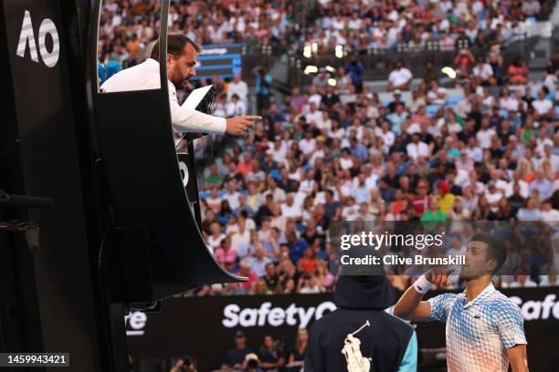 Novak Djokovic of Serbia speaks to the chair umpire in the Semifinal singles match against Tommy Paul of the United States during day 12 of the 2023...