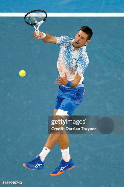 Novak Djokovic of Serbia serves in the Semifinal singles match against Tommy Paul of the United States during day 12 of the 2023 Australian Open at...