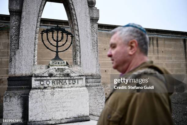 Man prays in front of a Jewish tomb during the commemoration of the Jewish victims of the Nazi deportation inside the Jewish Cemetery of Turin on...