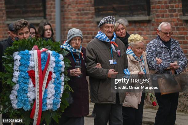 Survivors of the Auschwitz concentration camp and families arrive to lay wreaths honoring victims of the Nazi regime by the death wall during the...