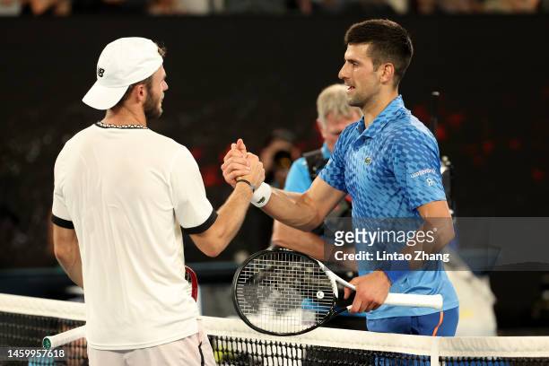 Novak Djokovic of Serbia and Tommy Paul of the United States embrace at the net in the Semifinal singles match against during day 12 of the 2023...