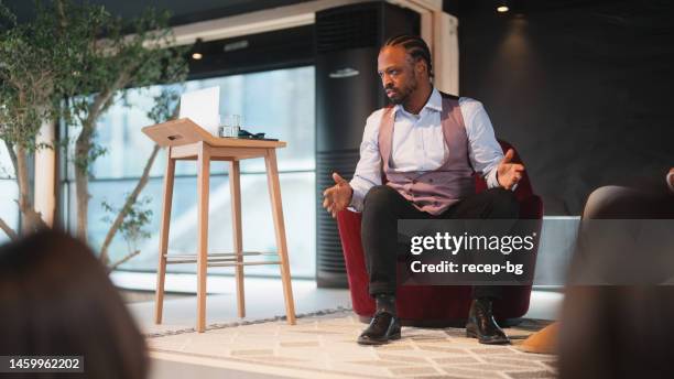 businessman talking to group of business people - conference presenter stock pictures, royalty-free photos & images