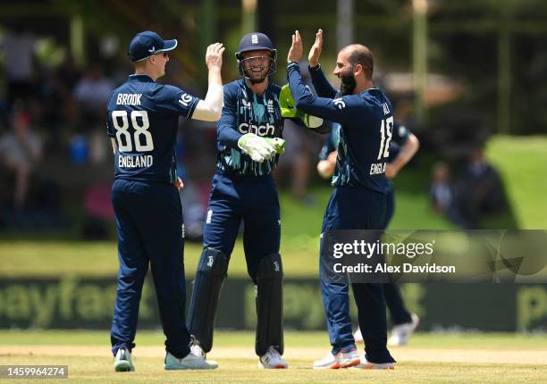 Moeen Ali of England celebrates with team mates Harry Brook and Jos Buttler after taking the wicket of Temba Bavuma of South Africa during the 1st...