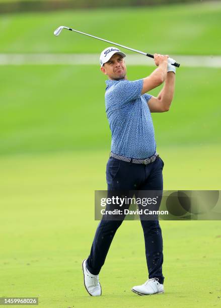 Louis De Jager of South Africa plays his second shot on the first hole which he holed out with for an eagle 2 during the completion of his first...