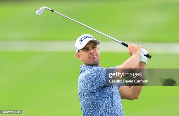 Louis De Jager of South Africa plays his second shot on the first hole which he holed out with for an eagle 2 during the completion of his first...