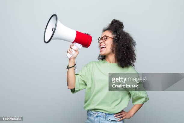 portrait of a female young volunteer - megaphone stock pictures, royalty-free photos & images