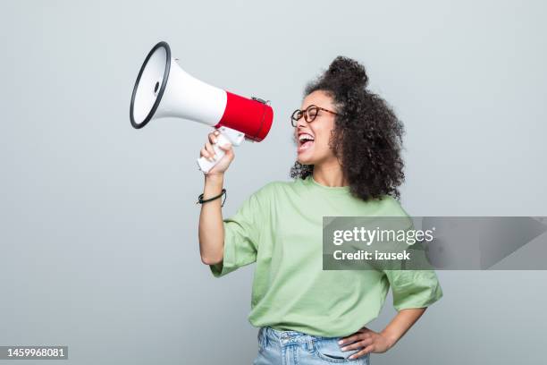 portrait of a female young volunteer - megafone imagens e fotografias de stock