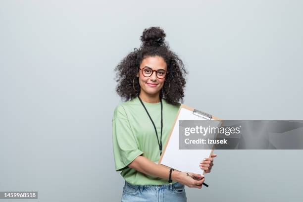 portrait of a smiling young volunteer - clipboard stock pictures, royalty-free photos & images
