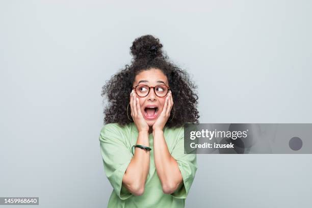 portrait of a terrified young woman - fear stock pictures, royalty-free photos & images