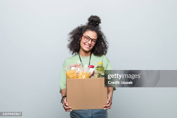 young volunteer holding donation box - woman hold box imagens e fotografias de stock