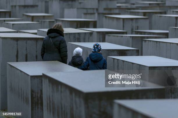 Visitors stand at Holocaust Memorial on the International Holocaust Remembrance Day on January 27, 2023 in Berlin, Germany. Holocaust Remembrance...