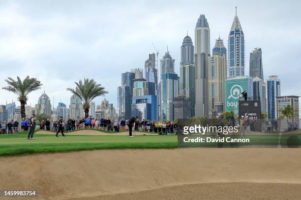 Tyrrell Hatton of England, Shane Lowry of Ireland and Francesco Molinari of Italy on the green on the eighth hole during the completion of his first...