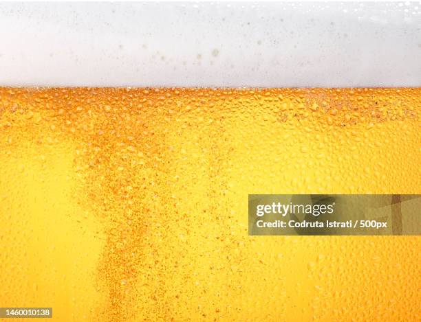 close up background of beer with bubbles in glass,romania - beer stock-fotos und bilder