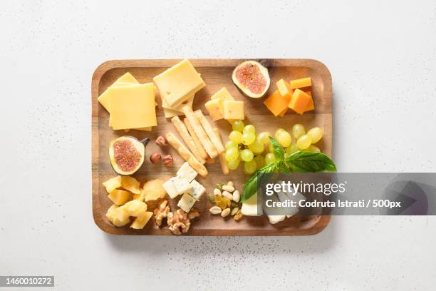 cheese platter with grapes,nuts,figs on a white,romania - cheese board photos et images de collection