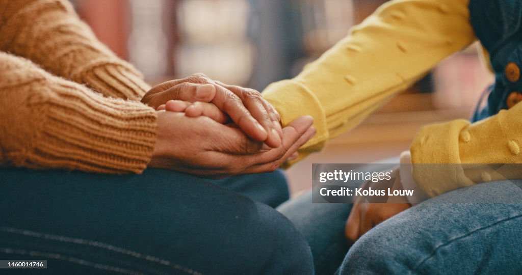 Hands, love and care touching in support, trust or unity for community, compassion or understanding. People holding hands in respect for loss, affection or passion for listening, talk or time