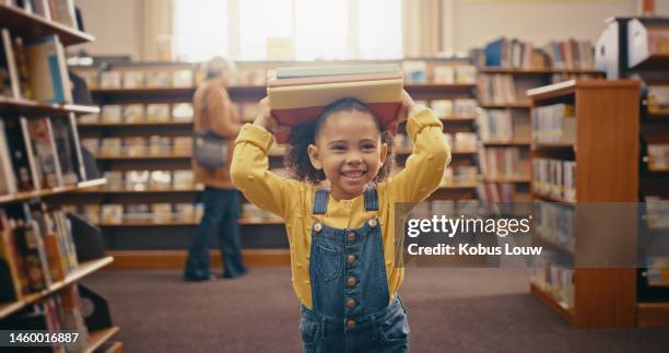 black girl holding books, library and happy with education, learning and story time with fun, smile and knowledge. african american female child, kid and young person with book, happiness and youth - picture book stock pictures, royalty-free photos & images